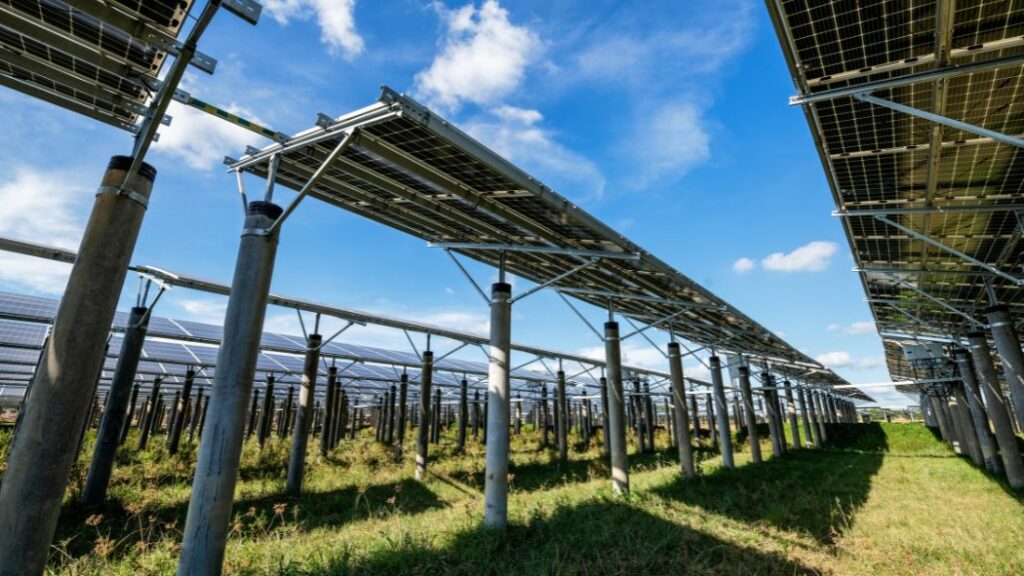 What Is a PV String and Why Is It Key in Industrial and Utility-Scale Solar Plants? 13 Row of photovoltaic modules at an industrial solar plant, showcasing the mounting structure on concrete pillars. A solar panel string is designed to maximize system voltage.